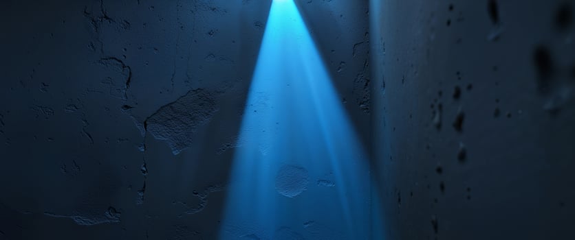 A blue light beam illuminating a textured dark wall photo