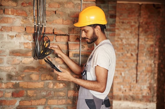 Wireless device in hands,, digital tablet. Handsome Indian man is on the construction site photo