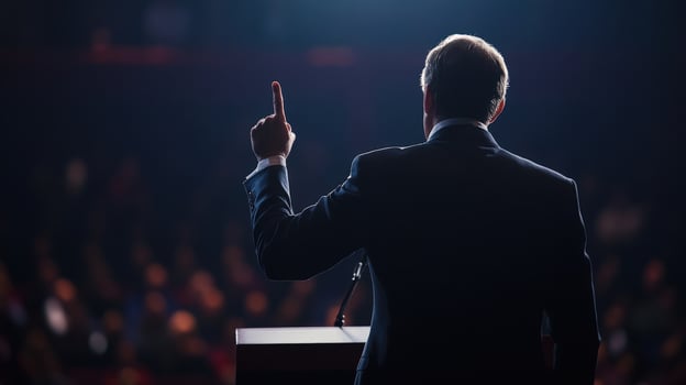 Politician giving speech to audience raising index finger photo