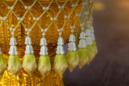 Uba is a flower that is strung in a string and attached to a bunch like a tassel for hanging on a tray with a pedestal or a flower garland photo