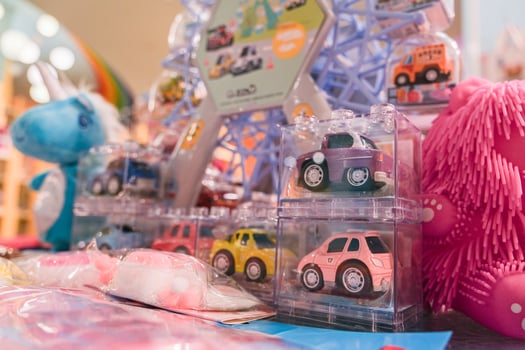 A display of toy cars and a stuffed animal photo