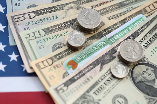 American US dollars money bills, green card on American flag close up photo