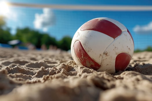 A red and white beach ball on the sand photo