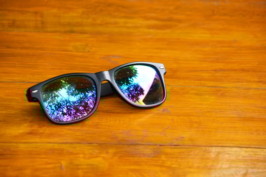 Black stylish sunglasses close up on wooden table photo