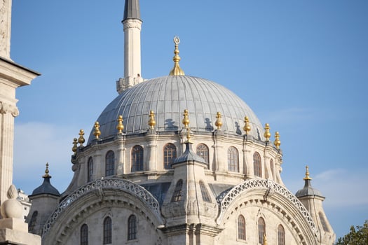 Dome of historical mosque shines under clear blue sky photo