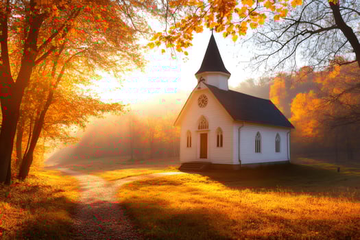Golden autumn sunlight illuminating small church in the forest photo