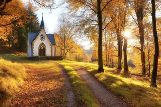 Sun shining through trees near small church in autumn forest photo