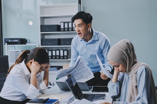 Angry asian businesswoman and her colleagues in office photo