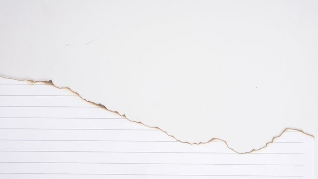 Close up stripped paper burns edge isolated on a white backgrounds photo