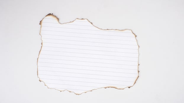 Burned edges white stripped paper isolated on white background photo