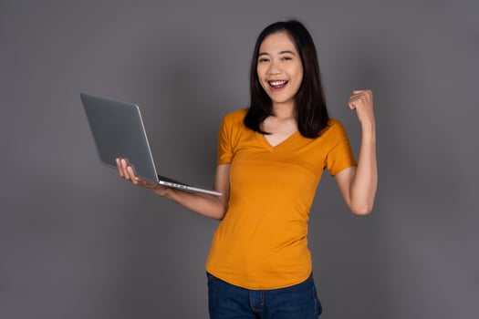Portrait of a Young Woman Holding a Laptop with a Confident Smile Isolated Background photo