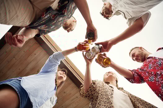 View from below. Group ,of people are with beer in hands having good time photo