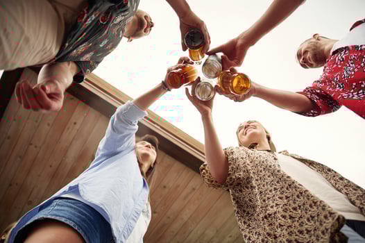 View ,from below. Group of people are with beer in hands having good time photo