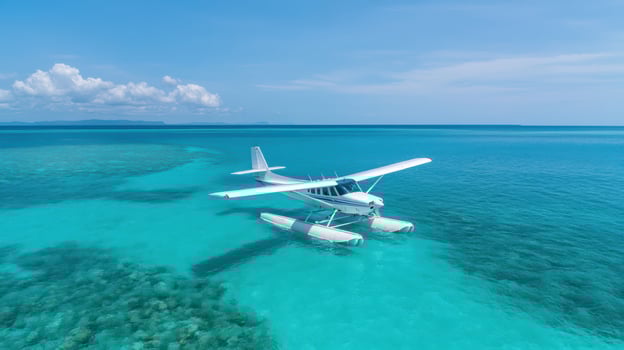 seaplane gliding over turquoise waters near coral reef, showcasing stunning scenery photo