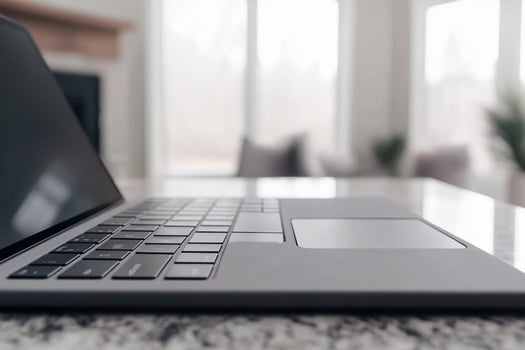 A laptop is sitting on a table in front of a fireplace photo