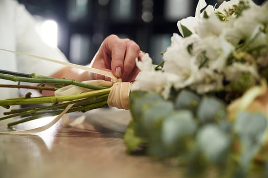 Close, up view, of woman that is working with flowers in the shop photo