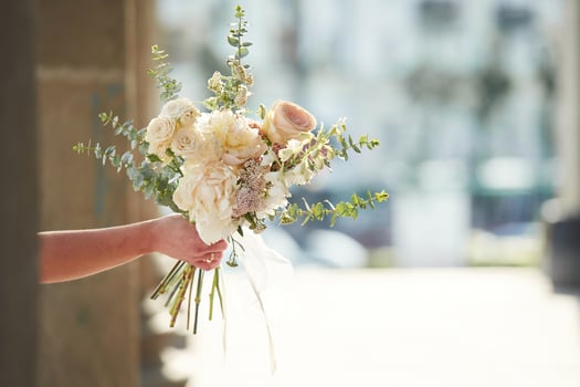 City ,at background. Close up view of woman that is with flowers in hands photo