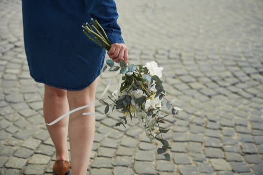 Legs,, walking forward. Close up view of woman that is with flowers in hands photo