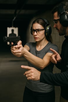 Woman Receives Firearm Training in Indoor Shooting Range for Skill Development and Safety photo