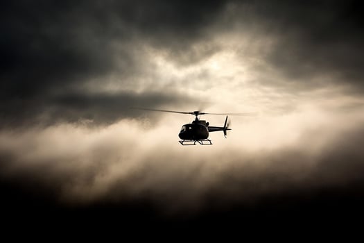 A helicopter flying through the clouds on a cloudy day photo