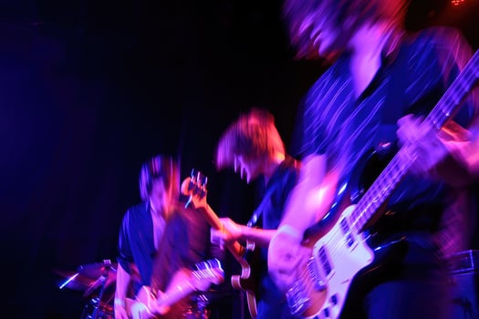 Energy filled live performance by a rock band at a dimly lit music venue in the city photo