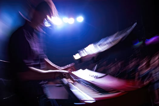 Musician performing with energy at a vibrant concert with lights and crowd at night photo