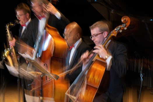 Musicians perform during a dynamic jazz concert at an indoor venue in the evening photo