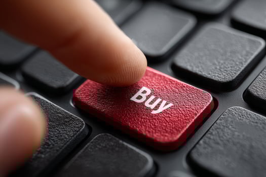 Finger presses buy button on computer photo