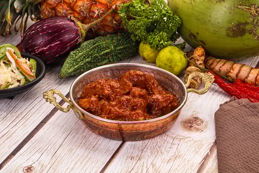 A wooden table with a bowl of food and other items photo