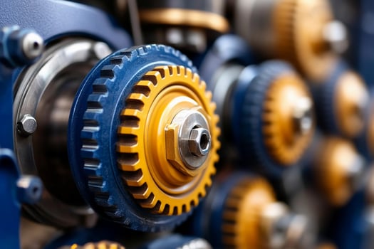 Closeup of blue and yellow gears on a machine photo