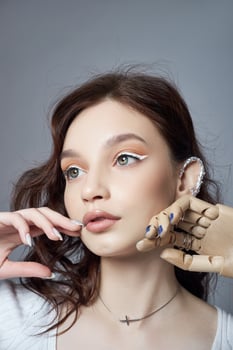 Beauty portrait woman with natural makeup and painted polished nails on her hand. Rings on the fingers of the hand photo