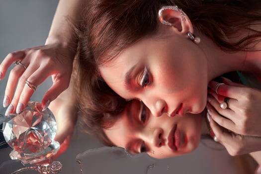Beauty Woman holds big diamond in hand while lying on table. Beautiful hands, professional manicure, large brilliant 1 photo