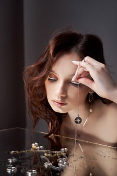 Beauty portrait beautiful woman, mirror reflection. Natural makeup, jewelry rings on your fingers photo