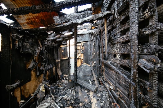 Consequences of fire, burnt wooden house... photo