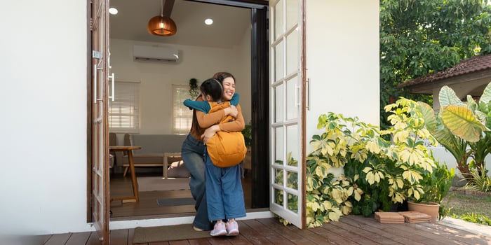Back to School and Mother-Daughter Bonding. A joyful reunion as a mother hugs her daughter after coming home from school. photo