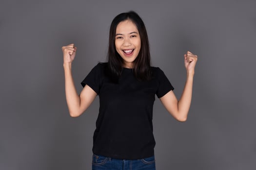 Young Woman Excitedly Raising Her Hand with Joy and Enthusiasm Isolated Background photo