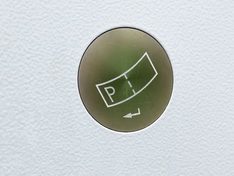 Close-up of circular sticker on textured surface with pt arrow design photo