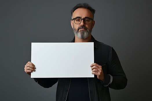 Man Holding Blank Signboard Against Gray Background photo