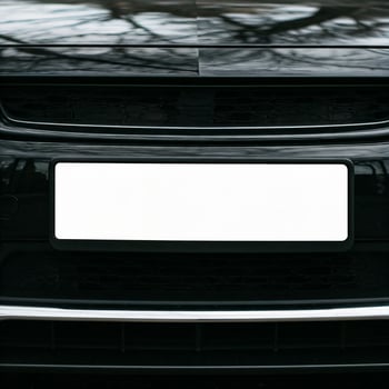 plain white license plate on a car bumper photo