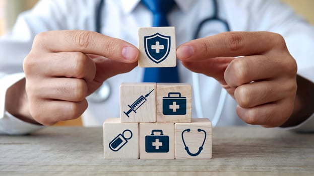 Doctor building healthcare protection concept with wooden blocks medical icons close up view photo