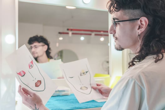 Make-up artist analyzing face charts in beauty salon photo