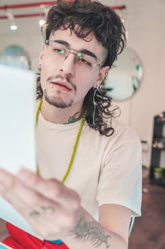 Young stylish man reading instructions in a hair salon photo