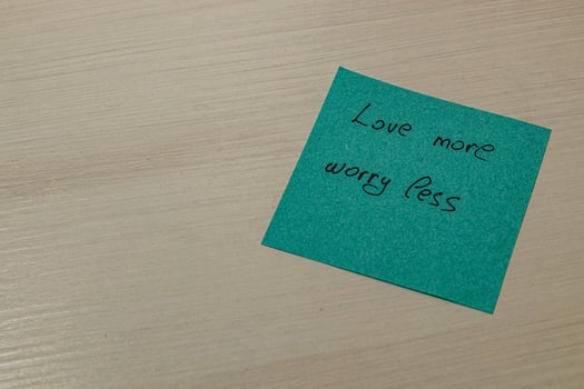 Turquoise note love more, worry less. photo