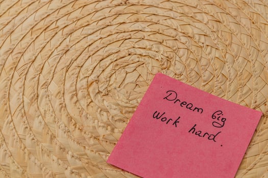 Inspiring message on colorful sticky note beside woven basket photo
