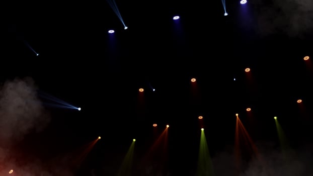 Stage lights. background. Light beams and smoke from the stage spotlights on the stage at time of show. Laser show isolated on black background. Empty stage with light projector illumination backdrop. photo