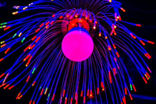 A colorful light bulb with a red and blue light photo