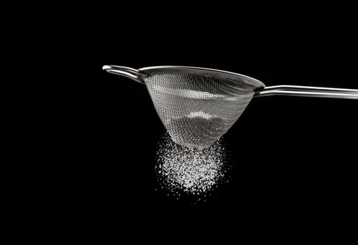 Sifting flour through a sieve photo