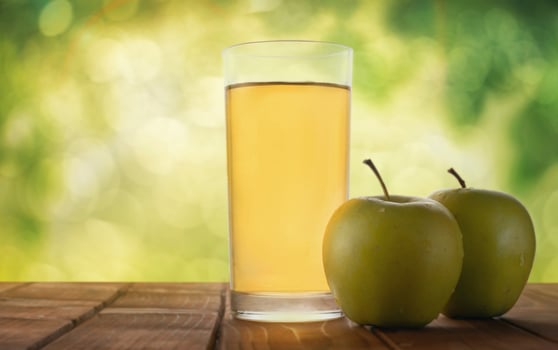 Apple juice on a table in the garden photo
