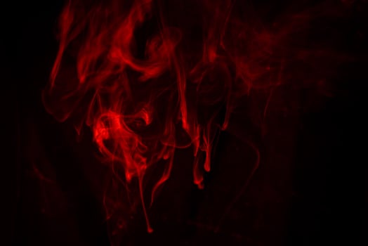 Texture of red smoke on black background photo
