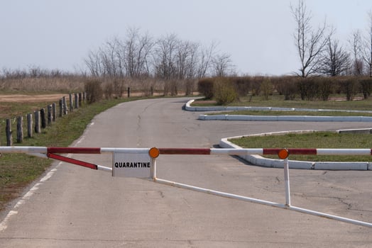 A white road with a red and white barrier photo